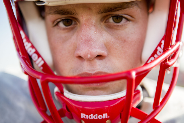 Arbor View High School quarterback Hayden Bollinger takes a break during football practice a ...