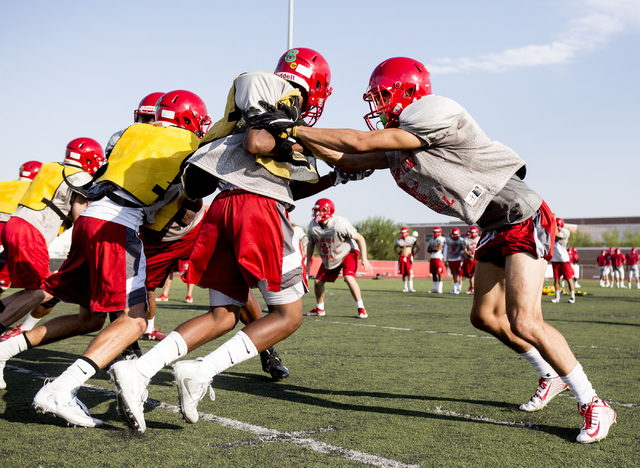 Arbor View High School wide receiver and cornerback Michael Sims, right, practices defense ...