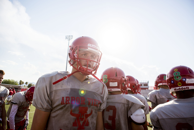 Arbor View High School quarterback Hayden Bollinger takes a break during football practice a ...