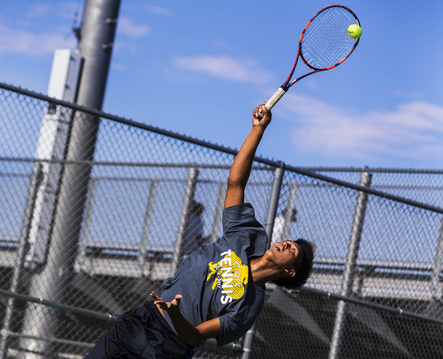Clark High School’s Marcus Pasimio fires a first serve during a home tennis meet again ...