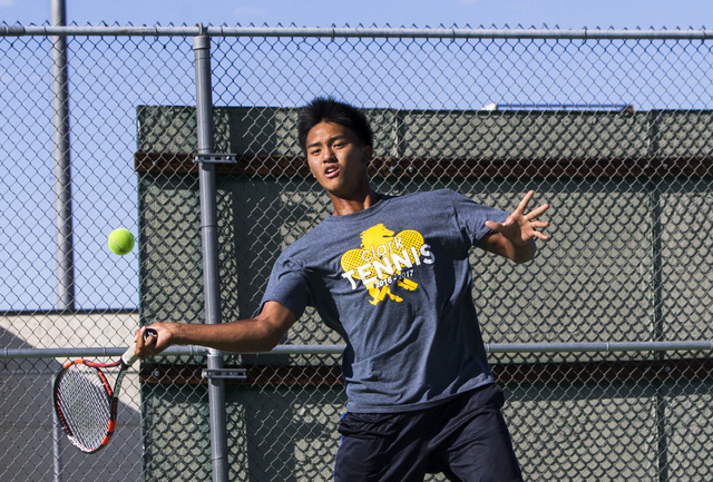 Clark High School’s Marcus Pasimio hits a forehand return during a home tennis meet ag ...