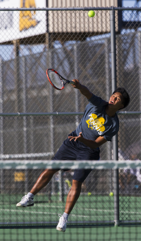 Clark High School’s Marcus Pasimio fires a first serve during a home tennis meet again ...