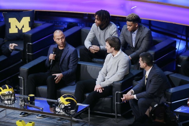 Derek Jeter, left, talks with former Michigan school quarterback Tom Brady and Michigan foot ...