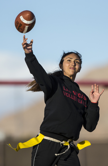 Wildcat quarterback Sabrina Saldate makes a pass during flag football practice at Las Vegas ...