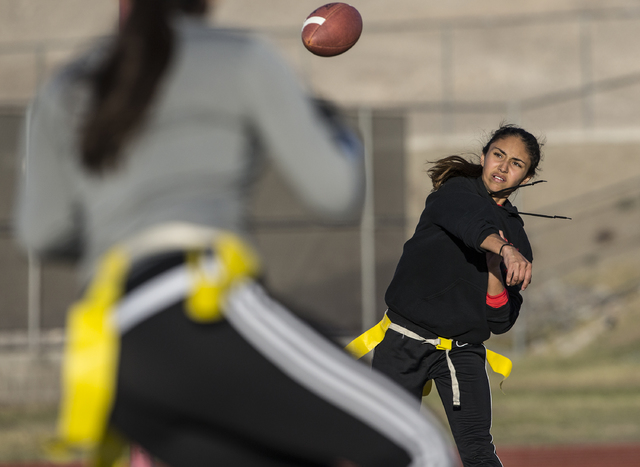 Wildcat quarterback Sabrina Saldate runs a passing drill during flag football practice at La ...