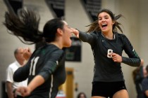 Palo Verde’s Arien Fafard (11) and Carli Tanner celebrate a point against Faith Luther ...