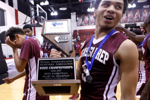 Agassi Prep’s Allen Merritt (5), right, holds the championship trophy after him and hi ...