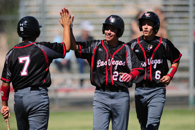 Las Vegas base runner Diego Delgado high fives Payton Miller (7) after scoring on a single h ...