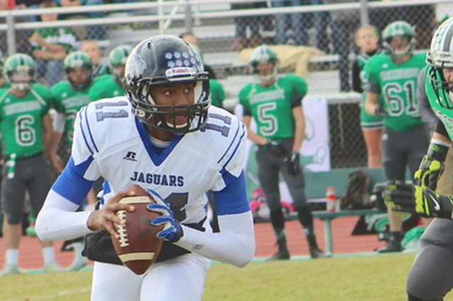 Desert Pines’ quarterback Marckell Grayson moves out of the pocket to avoid a tackle from ...