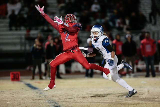 Liberty’s Ethan Dedeaux (2) reaches for a pass as Basic’s Brian Evans (9) defend ...