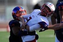 Bishop Gorman middle linebacker Nela Otukolo (10) tackles Liberty quarterback Kenyon Oblad ( ...