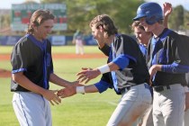 Basic’s Josh McLean, left, celebrates with Ryne Nelson, center, and teammates after hi ...