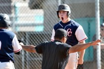 Coronado High School’s Nate Ruiz reacts after sliding safely across home plate during ...