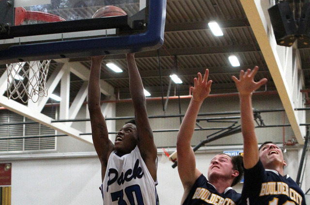 Basic forward Rob Sutton (30) goes up for a shot in front of Boulder City forward Brooks Roe ...