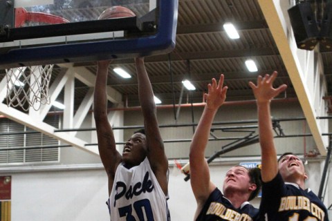 Basic forward Rob Sutton (30) goes up for a shot in front of Boulder City forward Brooks Roe ...