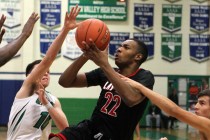 Las Vegas shooting guard Patrick Savoy (22) looks to shoot between Green Valley’s Bran ...