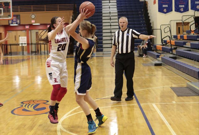 Liberty’s Kealy Brown (20) defends Skyline’s Hannah Anderl (15) during the secon ...