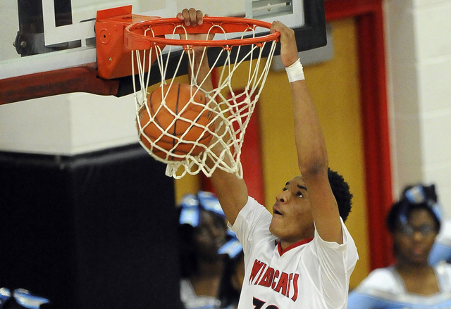 Las Vegas High forward Tyler Bey (30) dunks against Canyon Springs during the first quarter ...