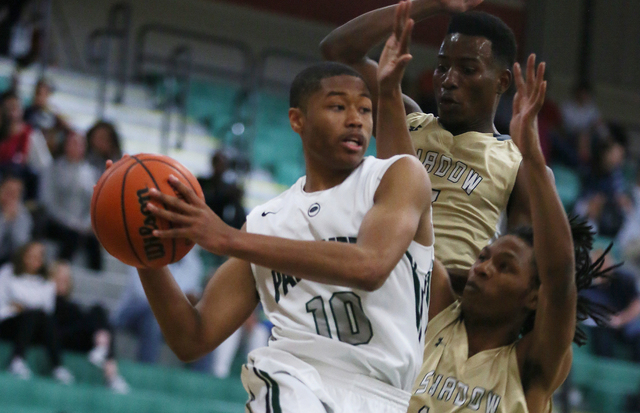 Palo Verde’s Ja Morgan, left, jumps to pass the ball around Shadow Ridge’s Melvi ...