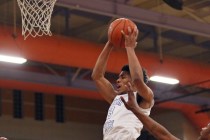 Desert Pines’ Trevon Abdullah, center, goes up for a rebound during a game against Chaparr ...