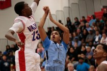 Canyon Springs senior Jordan Davis (1) shoots a jumper over Valley senior Nick Brannon (23) ...