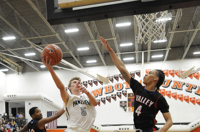 Palo Verde forward Grant Dressler (5) scores on a layup as Valley forward Taveon Jackson (4) ...