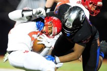 Bishop Gorman linebacker Farrell Hester, right, tackles Arbor View running back Curtis Jones ...