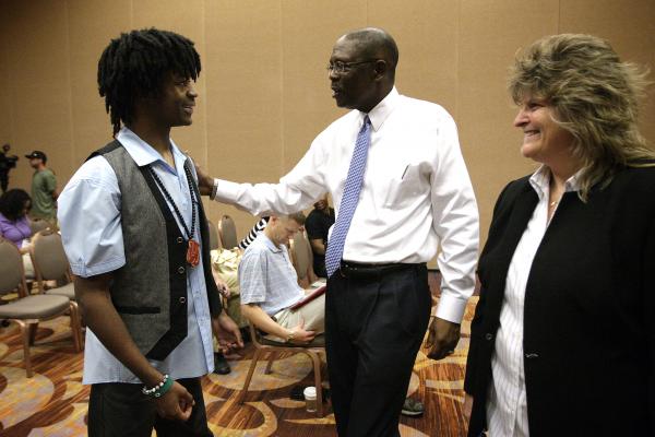 Former Green Valley linebacker LaQuan Phillips, left, is greeted by Clark County School Dist ...