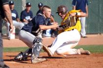 Brett Doyle slides past Centennial catcher Noah Given to score on Dave Estrada’s fifth-inn ...