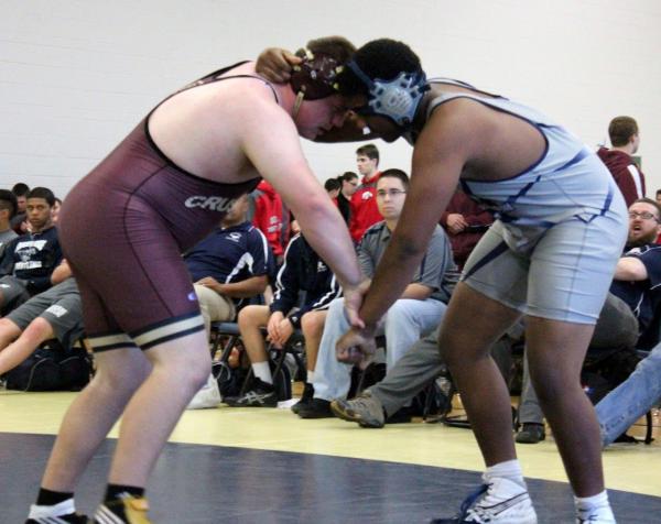 Faith Lutheran junior heavyweight Ethan Wolfe ties up with Shadow Ridge junior August Forest ...