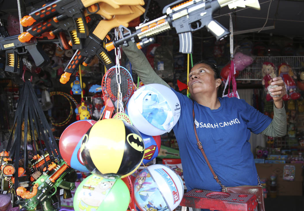 Irene Flores, owner of Factory Toys, prepares for business at the Broadacres Marketplace in Nor ...