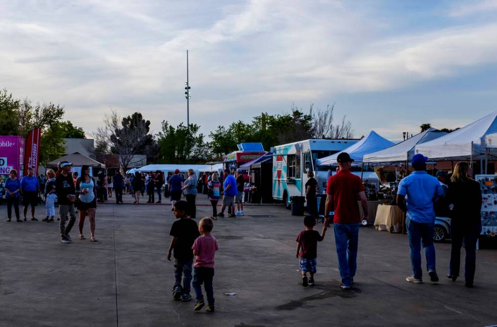 People walk around the event plaza on Water Street in Henderson for a Last Friday event on Frid ...