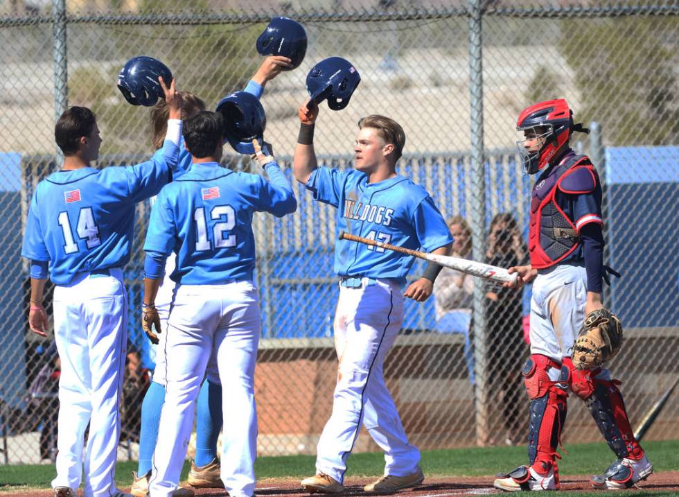 Centennial's Austin Kryszczuk (47) celebrates with his teammates after hitting a 3-run homer as ...