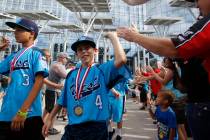 Mountain Ridge Little League players Dominic Clayton (3), left, and Drew Laspaluto (4), high fi ...