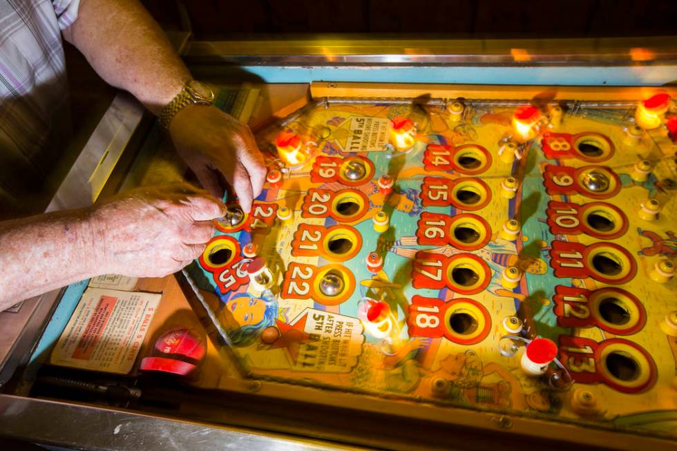 Jerry Kaczmarek plays on the "Circus Queen" bingo pinball machine at his home in Bull ...