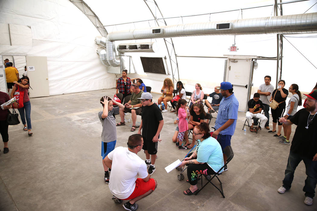 People wait to be processed and take home their new pets during the national Clear the Shelters ...