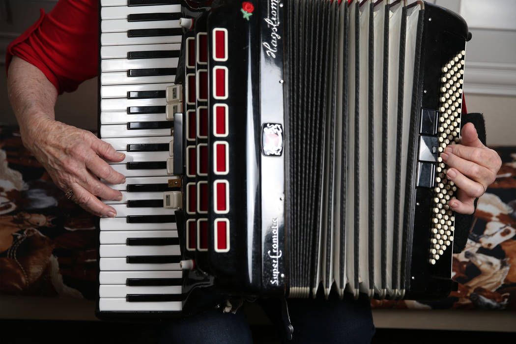 Etta Baykara, 91, plays accordion at her home in Las Vegas, Tuesday, July 30, 2019. Baykara wro ...