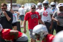 UNLV football coach Tony Sanchez watches over his players as they runs through drills during te ...