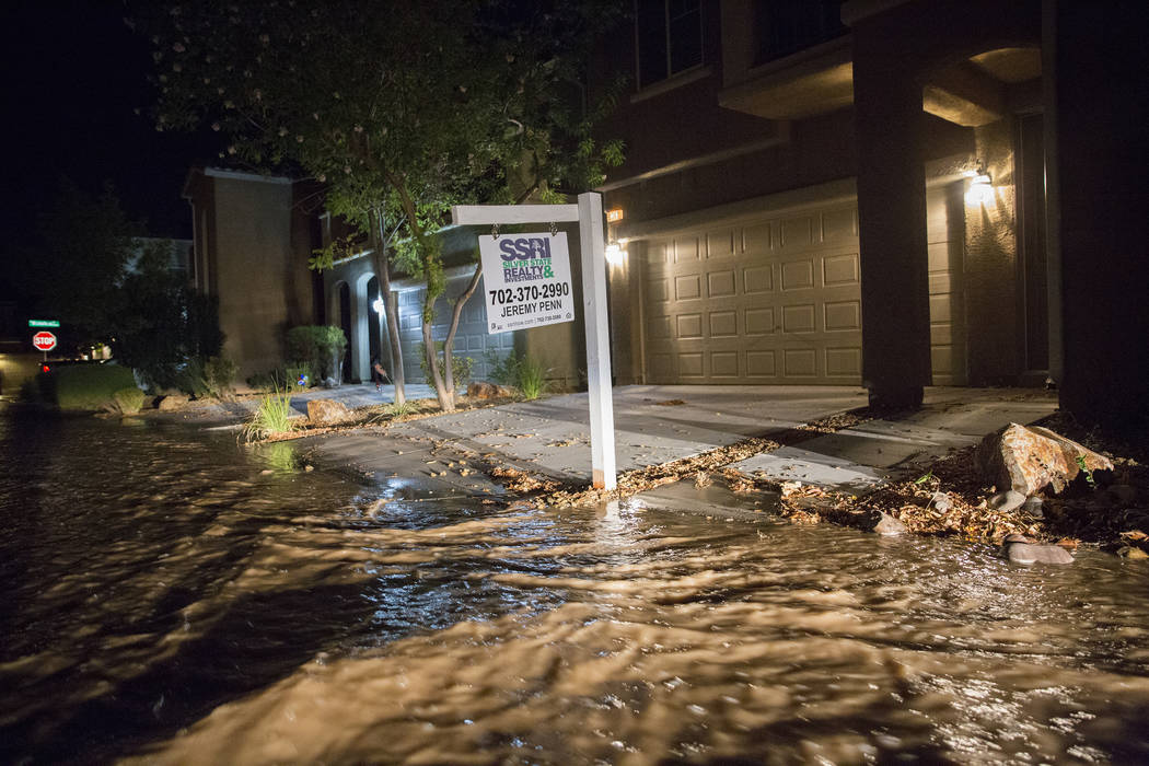 Southwest valley streets are flooded early Thursday morning, Aug. 1, 2019, in Las Vegas. (Benja ...