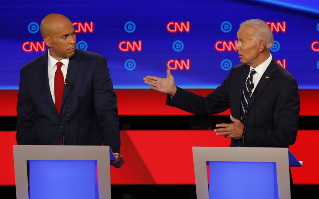 Sen. Cory Booker, D-N.J., listens as former Vice President Joe Biden speaks during the second o ...
