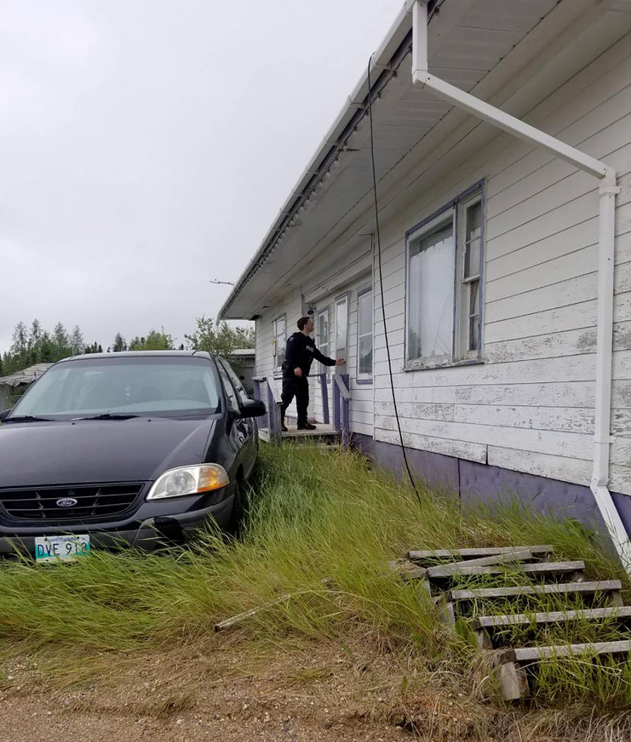 In this recent photo provided by the Royal Canadian Mounted Police, RCMP officers canvas homes ...