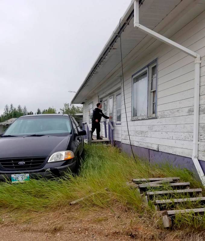 In this recent photo provided by the Royal Canadian Mounted Police, RCMP officers canvas homes ...