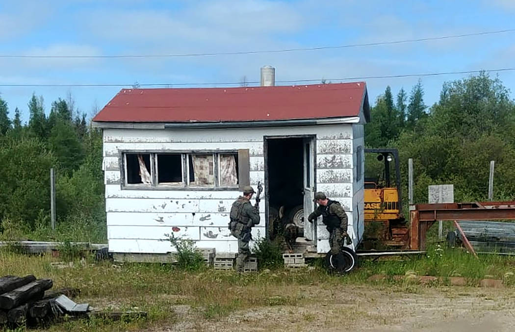 In this recent photo provided by the Royal Canadian Mounted Police, RCMP officers canvas homes ...