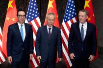 Chinese Vice Premier Liu He, center, poses with U.S. Trade Representative Robert Lighthizer, ri ...