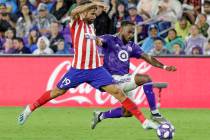 Atletico Madrid forward Diego Costa (19) pushes the ball past Minnesota United defender Romain ...