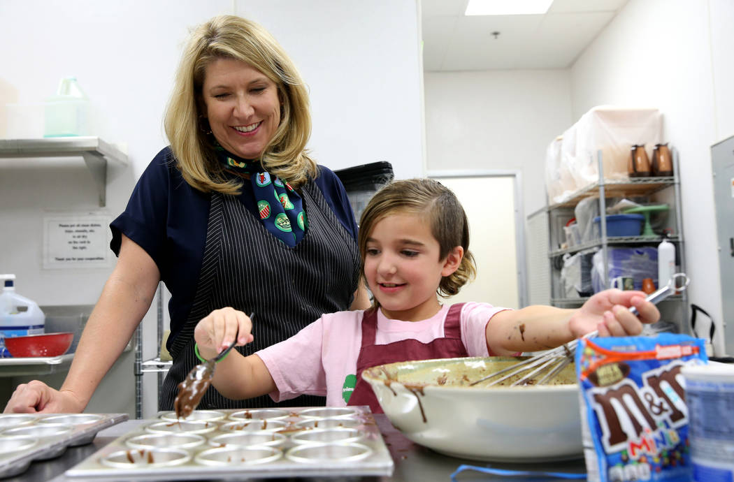 Kimberly Trueba, CEO of Girl Scouts of Southern Nevada, bakes with Sonia Perera, 7, during Camp ...