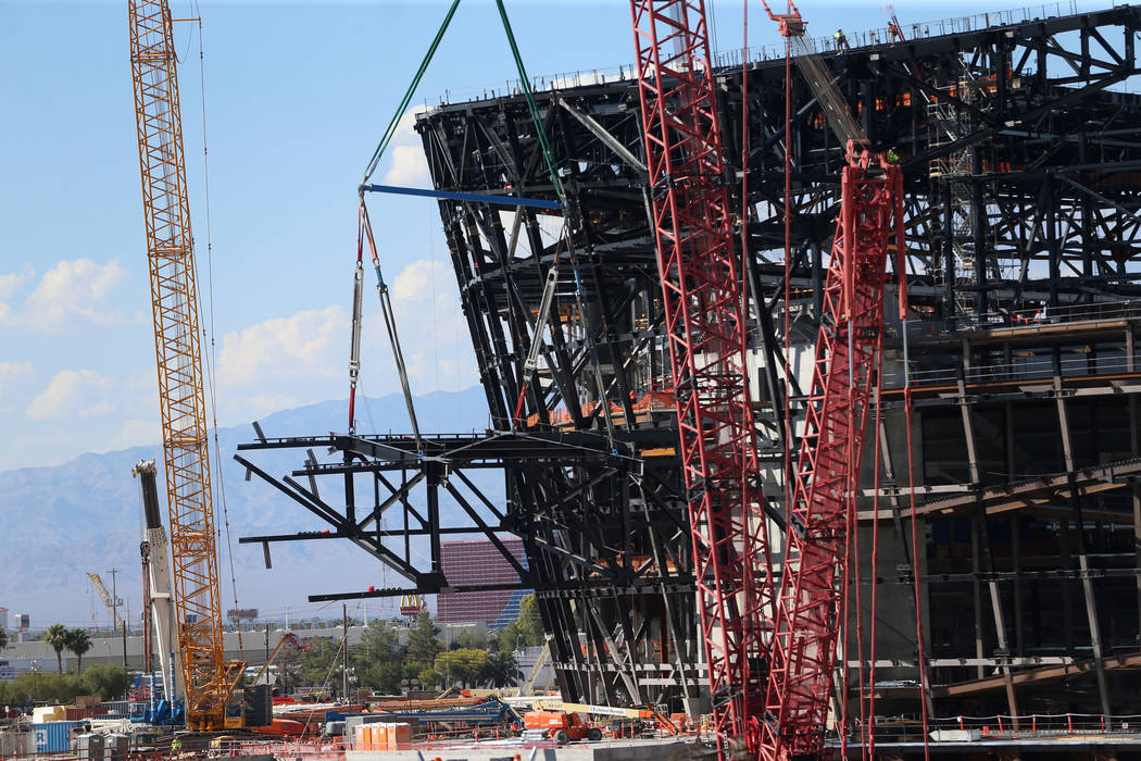 The final steel canopy truss goes up at the Raider stadium construction site in Las Vegas, Thur ...