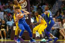 Dallas Wings' Isabelle Harrison, center, holds the ball during a WNBA basketball game against t ...