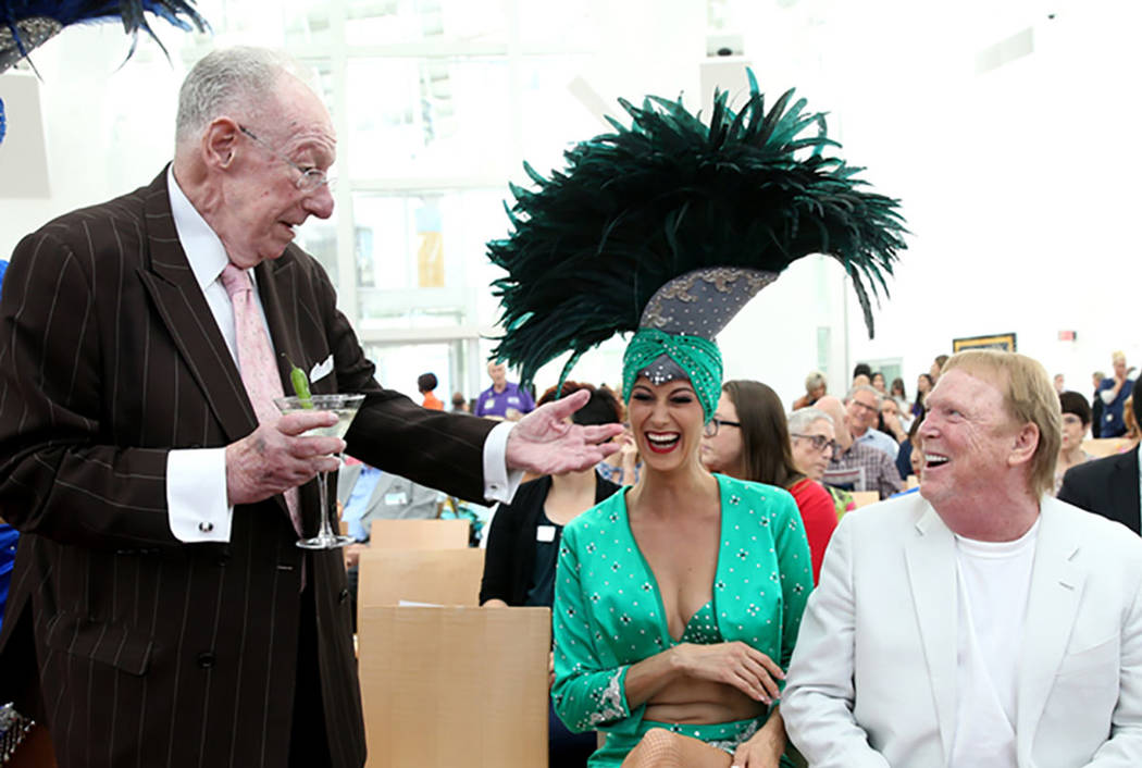 Former Las Vegas Mayor Oscar Goodman, left, with showgirl Carolin Feigs, greets Raiders owner M ...