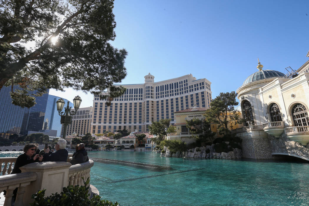 Tourists gather in front of the Bellagio Fountains on the Strip in Las Vegas, Monday, Feb. 11, ...